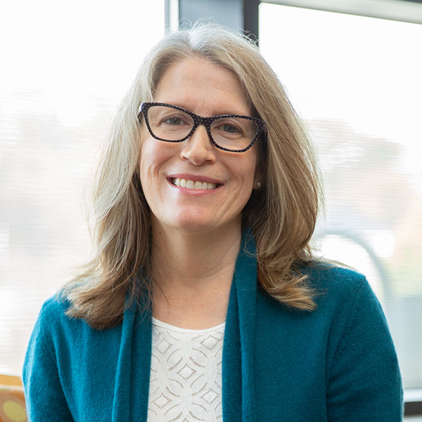 photo of faculty member sitting on chair in office
